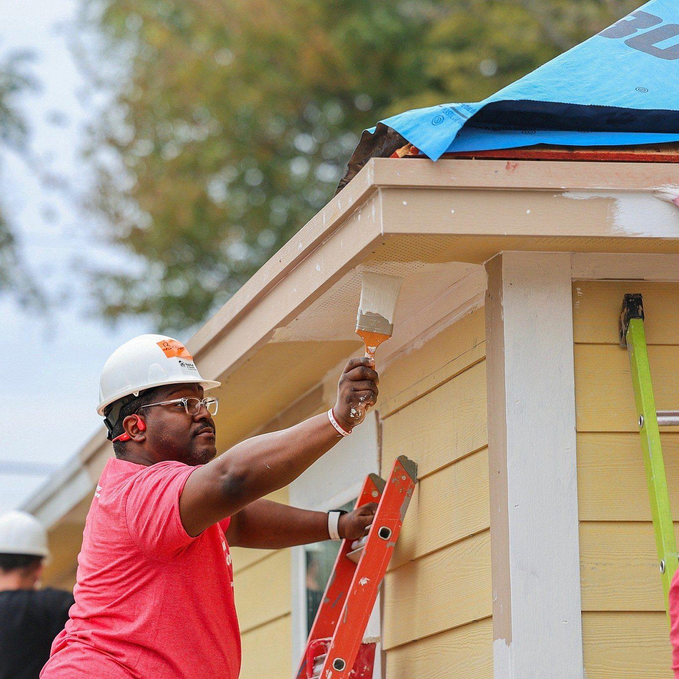 Volunteer painting house siding 2