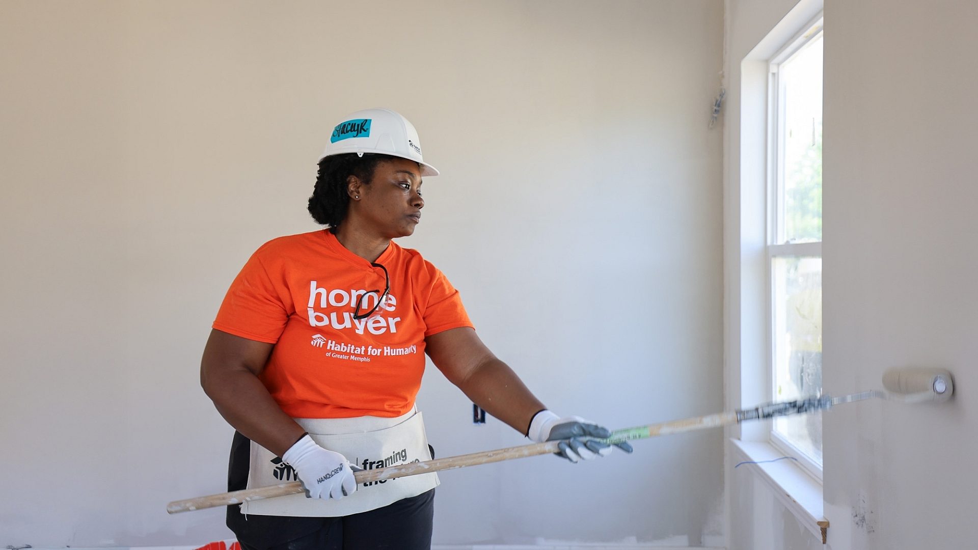 Volunteer painting wall